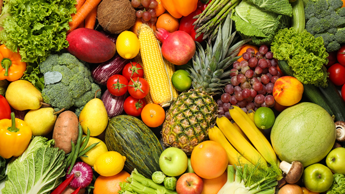 A vibrant assortment of fresh vegetables on a rustic wooden table.